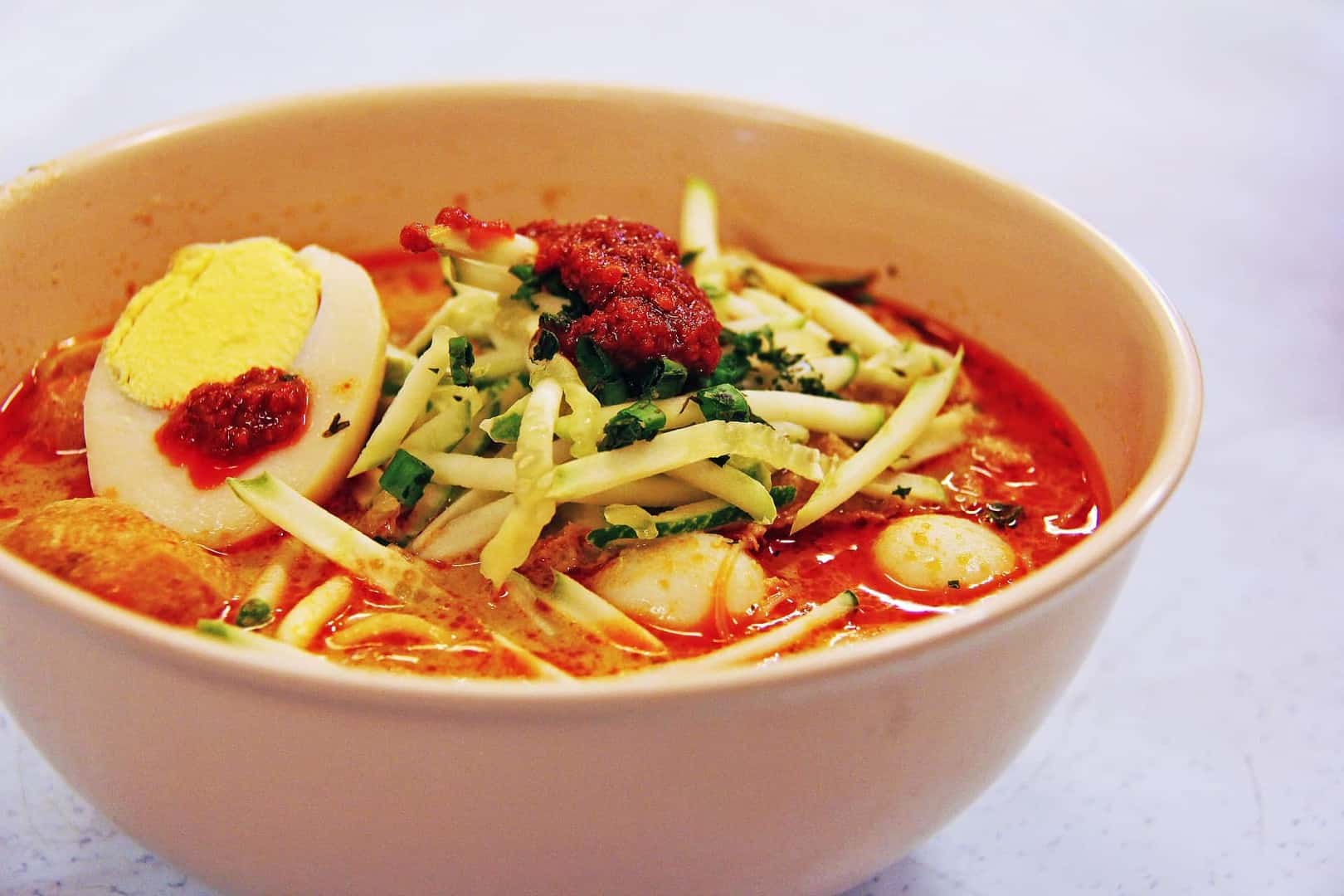 Laksa, a spicy noodle soup, is another favorite in Singapore