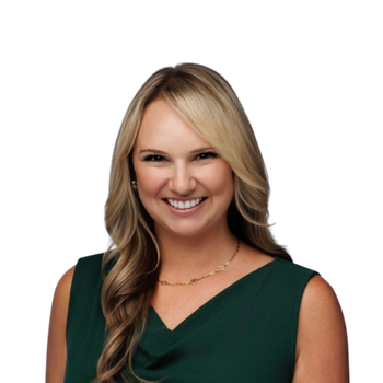 Woman with long blonde hair wearing a dark green sleeveless top, smiling at the camera against a plain white background.